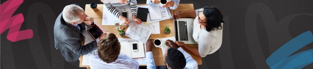 A group of people sitting at a table strategizing.