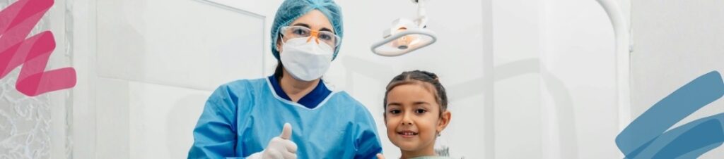 A dentist giving a thumbs up next to a child patient, both looking at the camera.