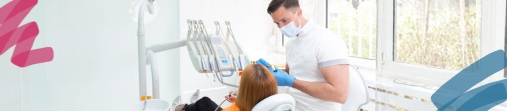 A dentist talking to a patient in the chair.