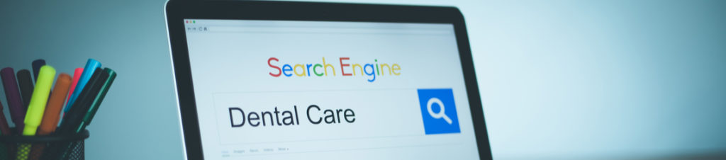 Someone searching "dental care" in a search engine, displayed on a laptop