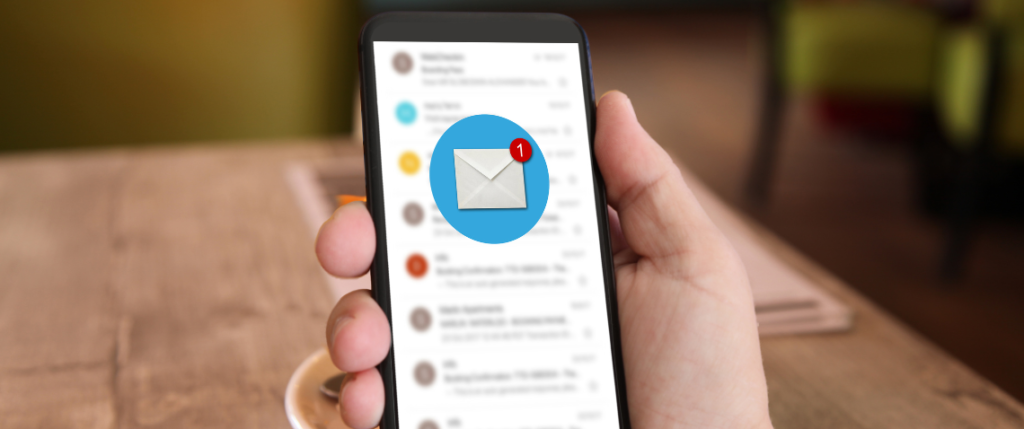 A hand holding a smart phone with an email icon notification